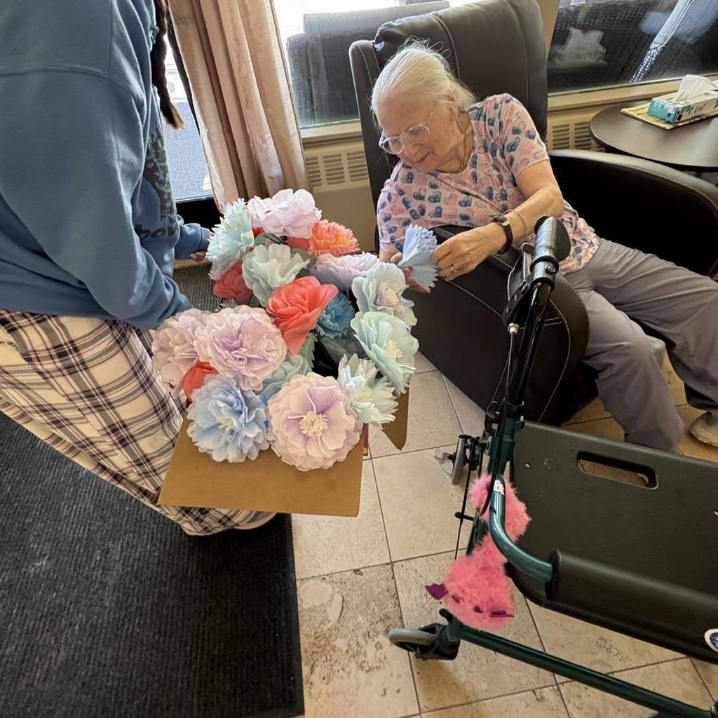 picture of woman receiving paper flowers