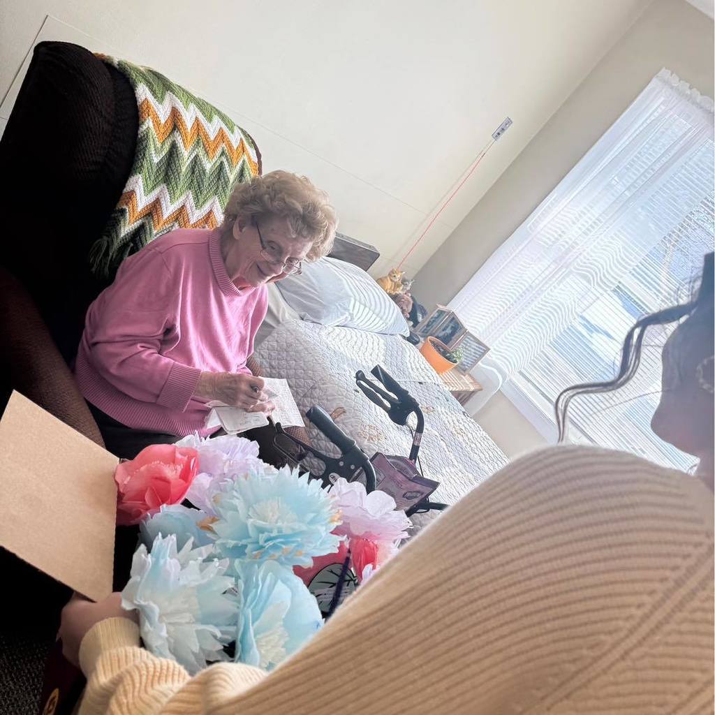 picture of woman receiving paper flowers