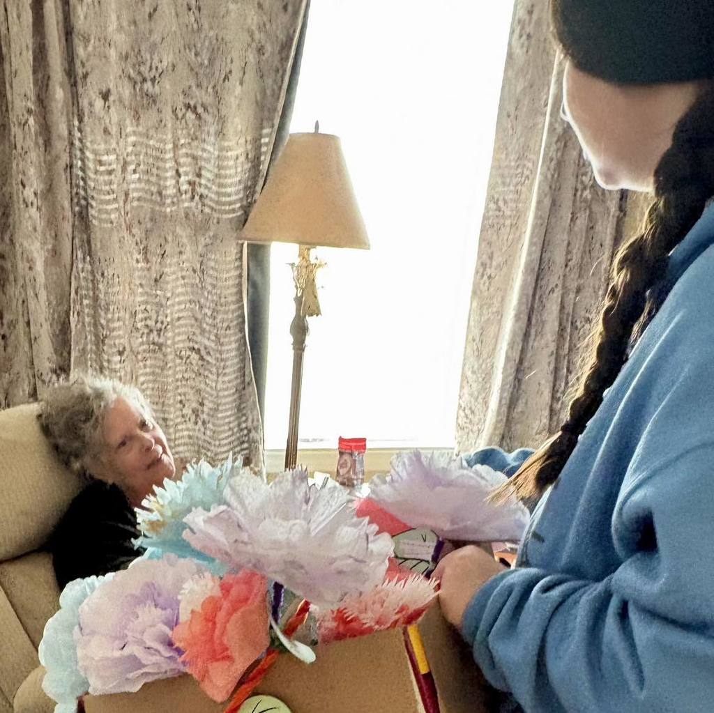 picture of woman receiving paper flowers