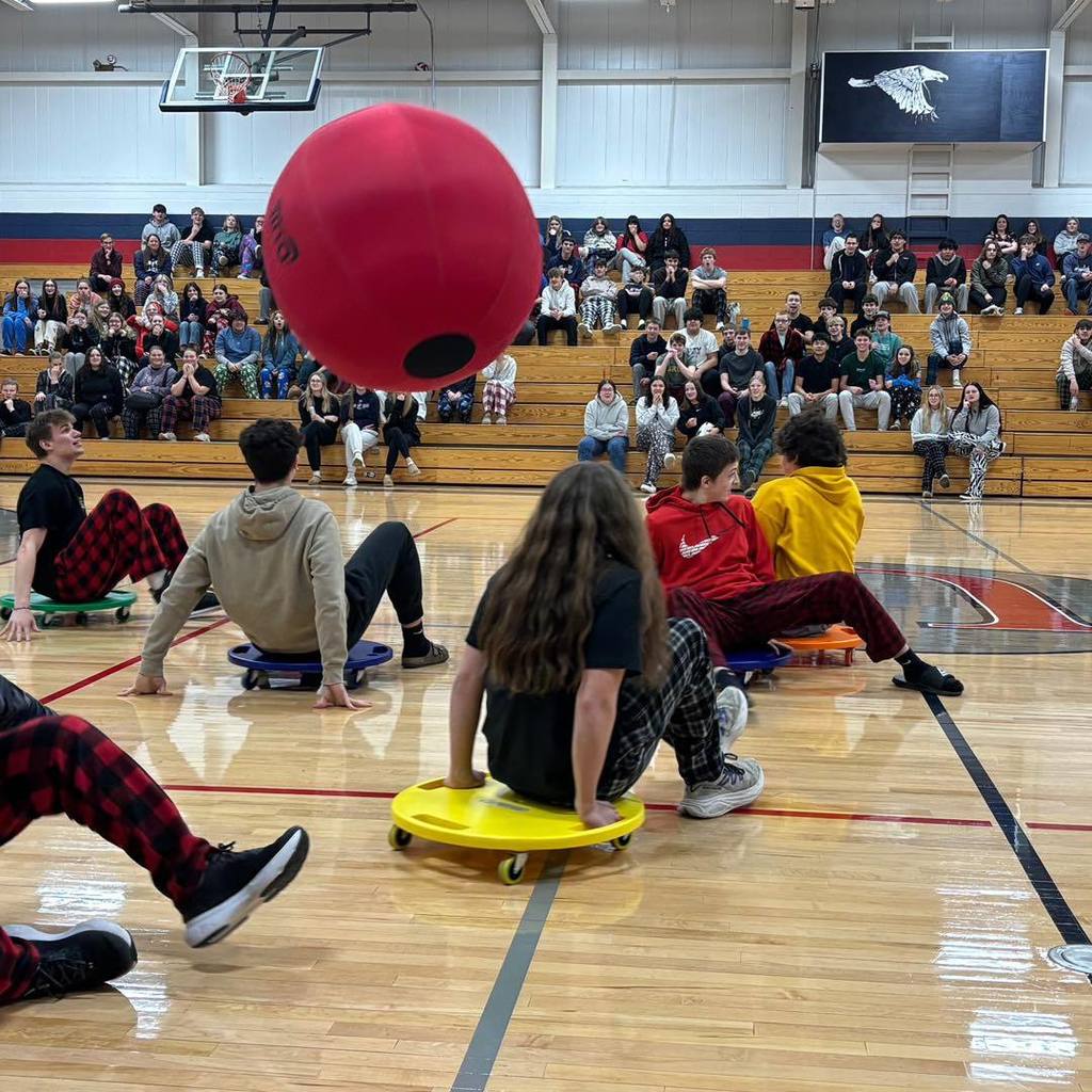 picture of students riding scooters in the gym