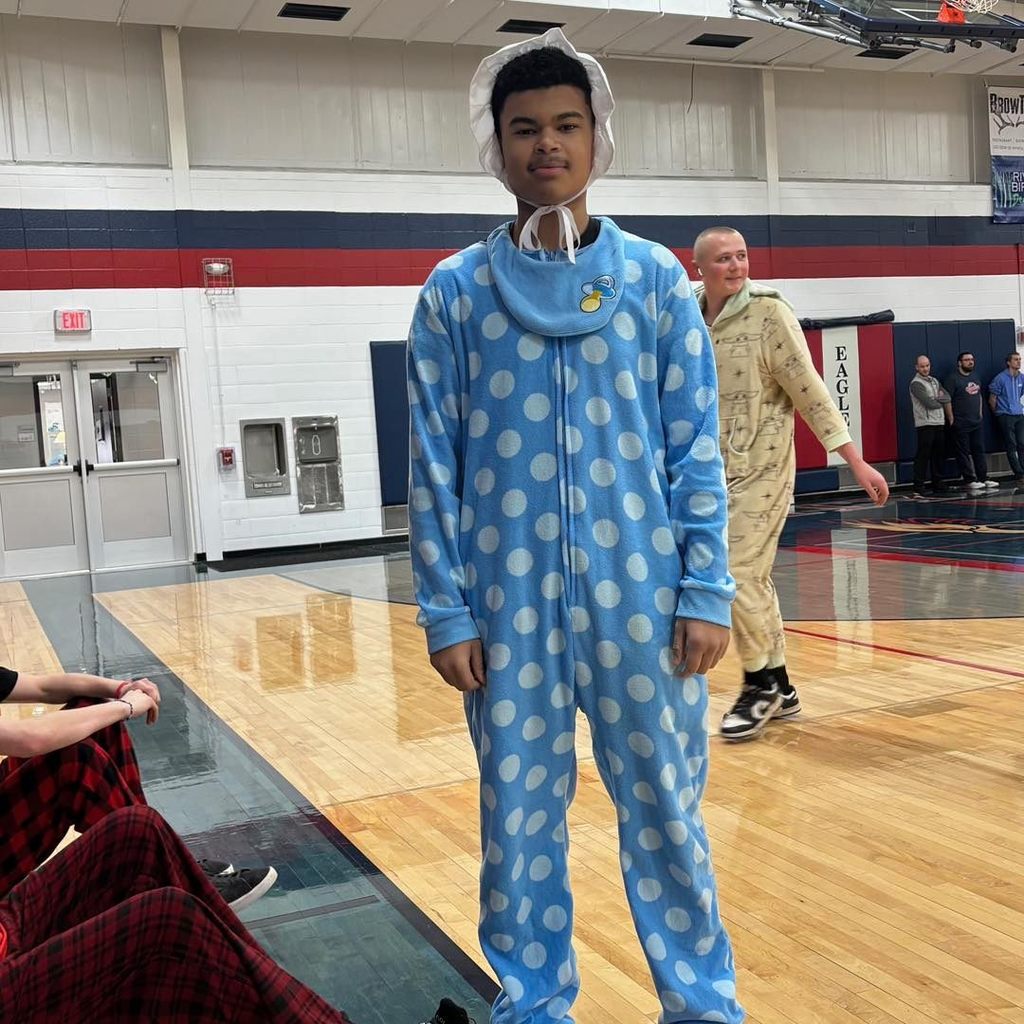 picture of student dressed like a giant baby with a big and pajamas