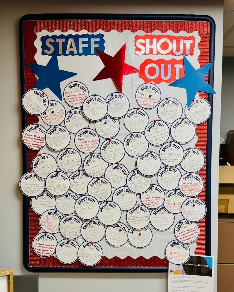 A bulletin board titled "STAFF SHOUT OUT" featuring dozens of small, circular notes pinned to a red background, with large red and blue star cutouts at the top.