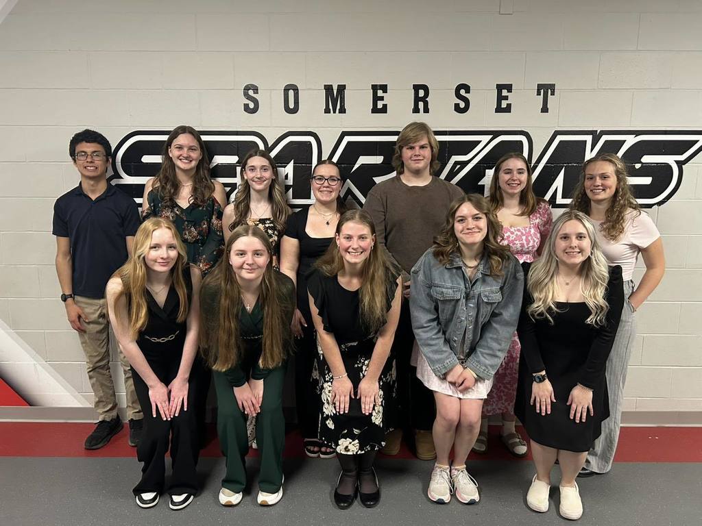 Unity high school music students smiling and posing for a group photo at Somerset High School after the District Solo & Ensemble event.
