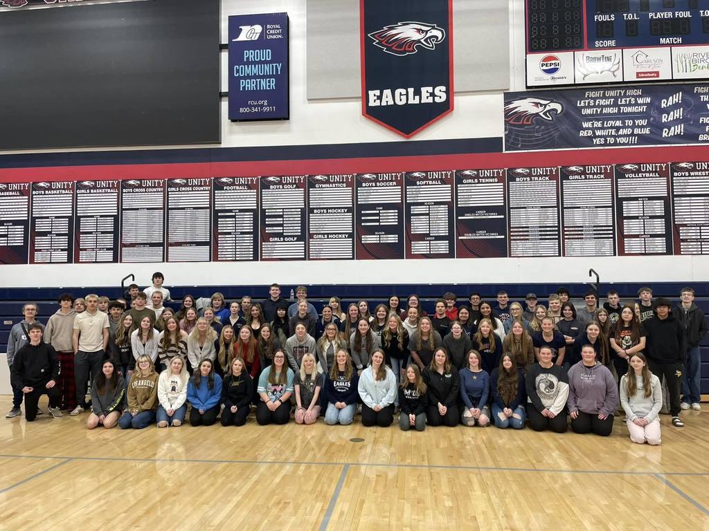 Unity School District students posing in the gym for their Trimester 2 Honor Roll group photo.