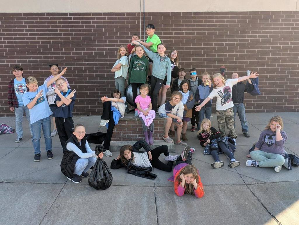 Unity Elementary Student Council students posing together for a group photo during their spring cleaning event on the school campus.