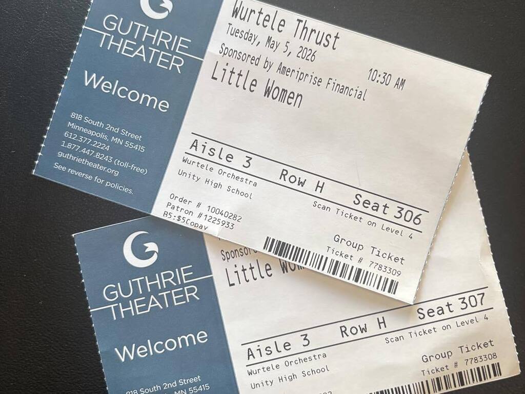 A close-up of two Guthrie Theater group tickets for a performance of 'Little Women' on May 5, 2026, issued to Unity High School, resting on top of a 'Welcome' information packet.