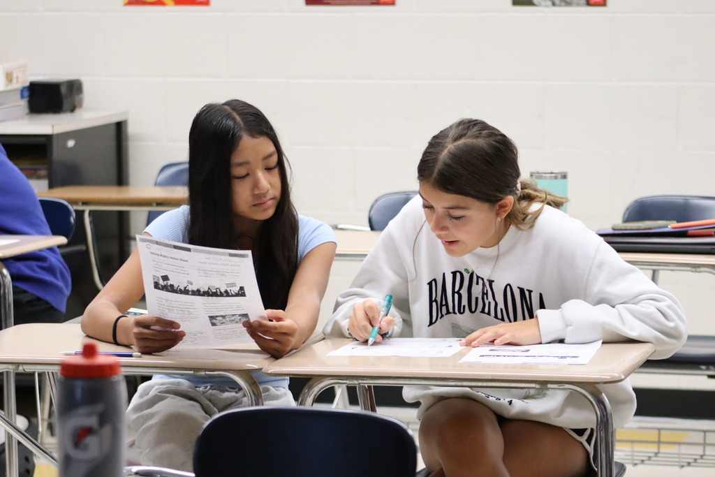 Two 8th grade students work on a worksheet as a pair.
