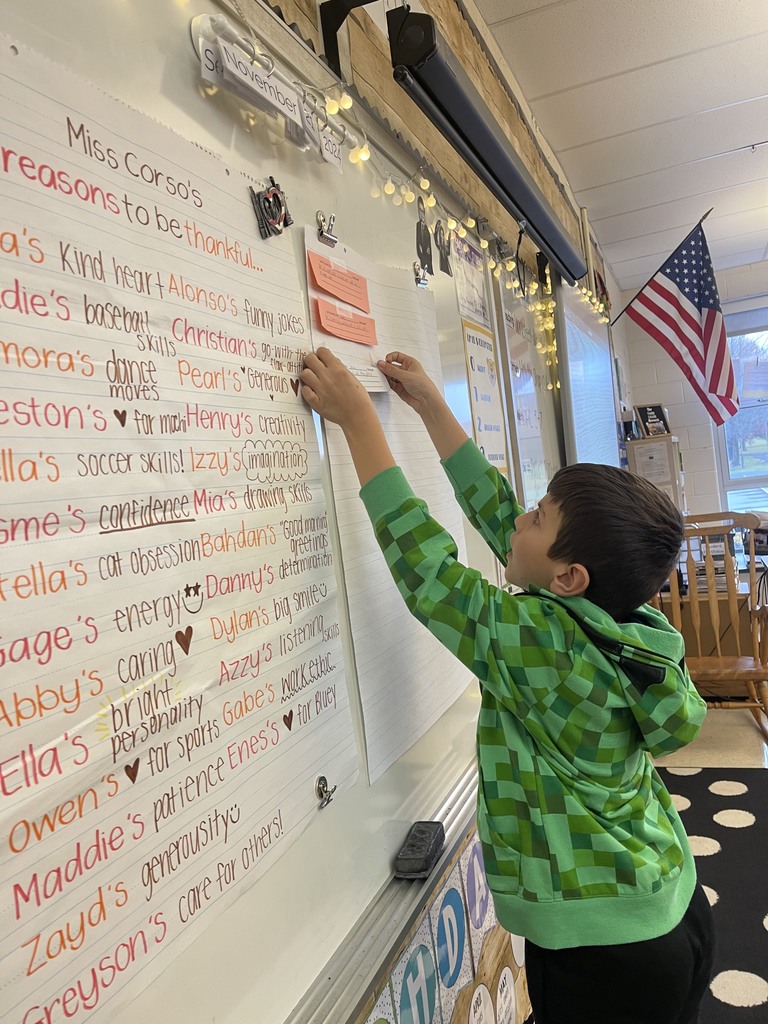 Student hanging their thank you note on the whiteboard