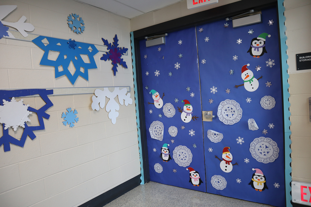 Snowmen and snowflakes decorating the door