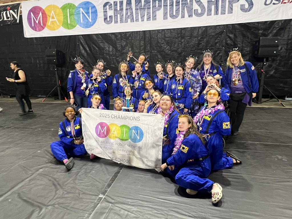 UMMS Winterguard Team group photo with medals and banner