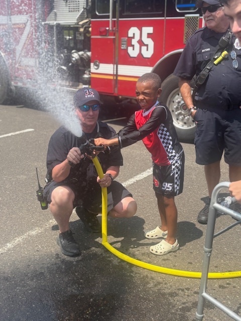 Student uses a fire house with a member of the fire company