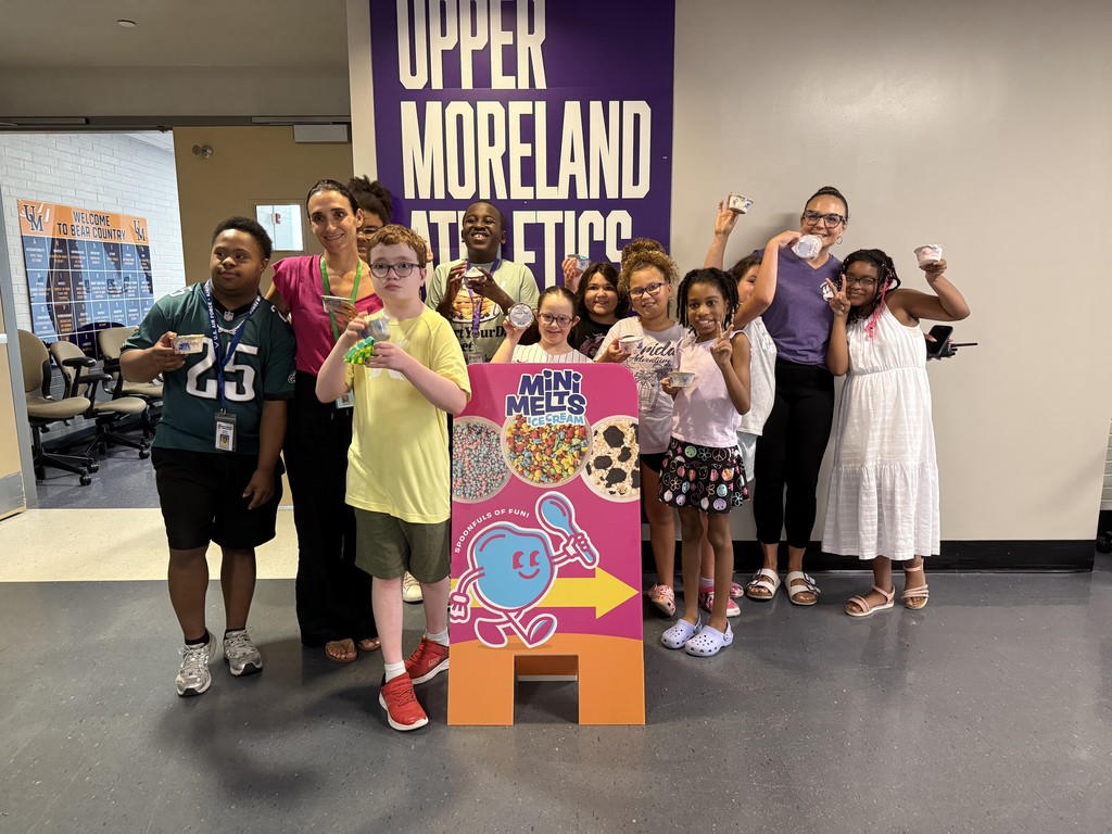 Students hold their Mini Melts Ice Cream and pose for a picture in a large group