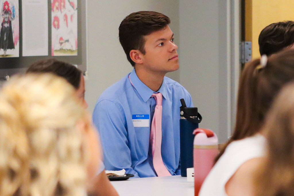 New teacher listening to Dr. Elliott's welcome message