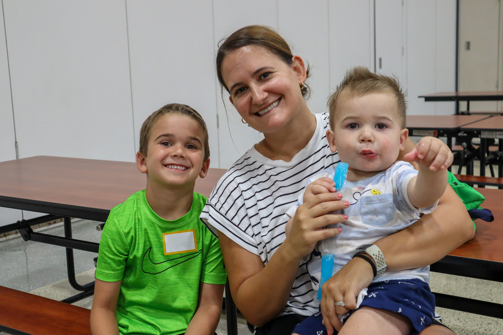 Family posing at a table with a popsicle