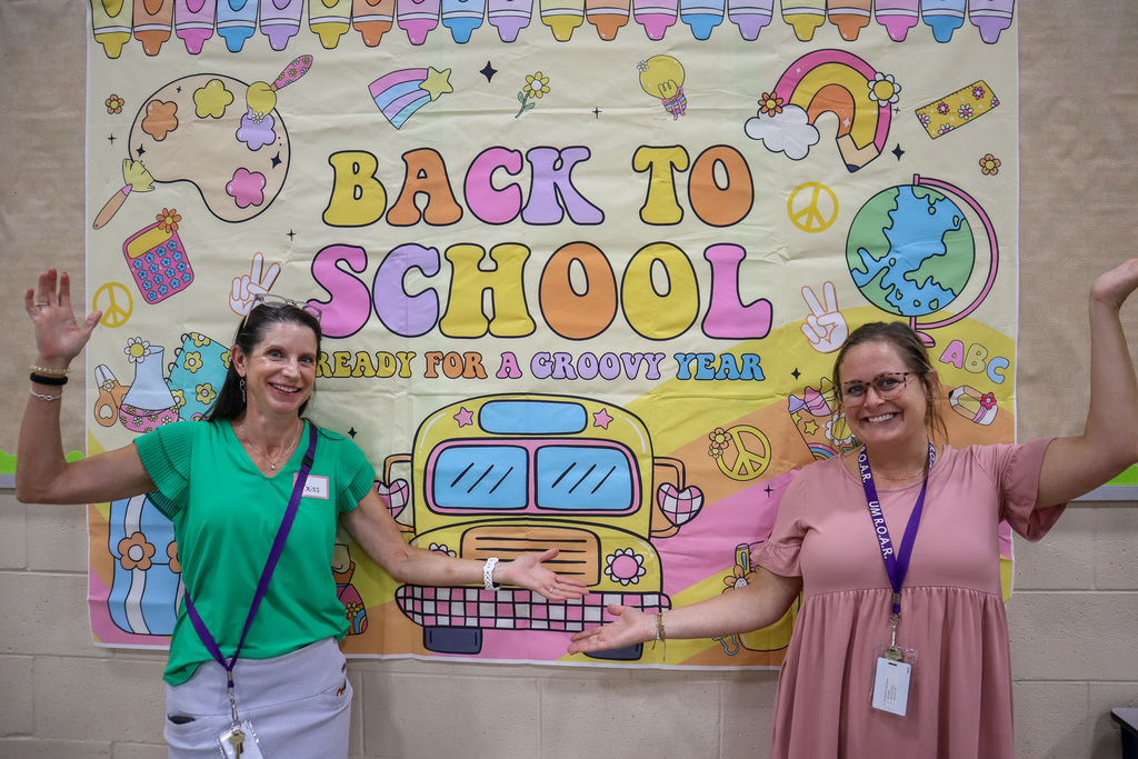 UMPS Principals posing next to Back to School sign