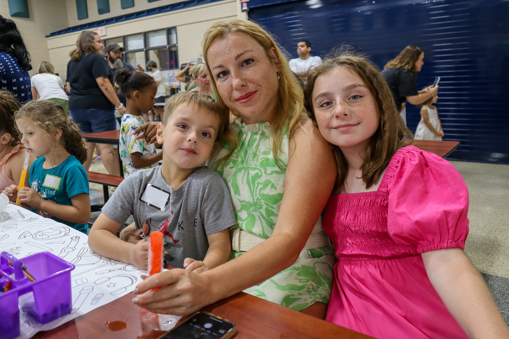 Family posing at a table with a popsicle