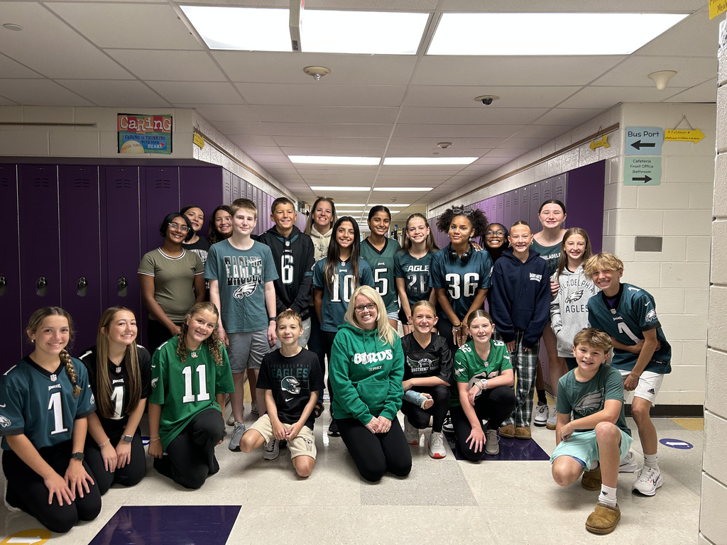 UMMS students pose for a photo wearing their Eagles gear