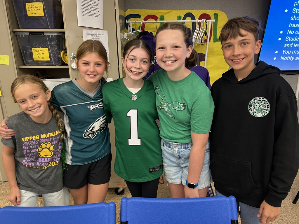 UMIS students pose for a photo wearing their Eagles gear