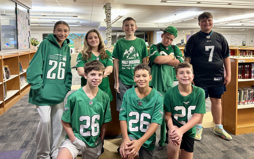 UMMS students pose for a photo wearing their Eagles gear
