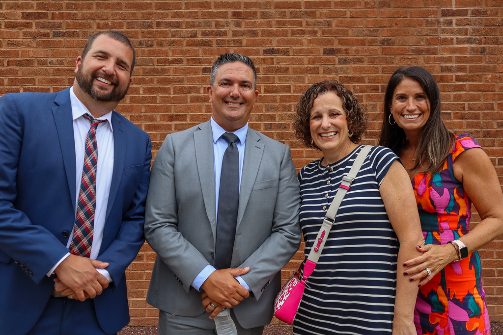 Administrators smile for a photo