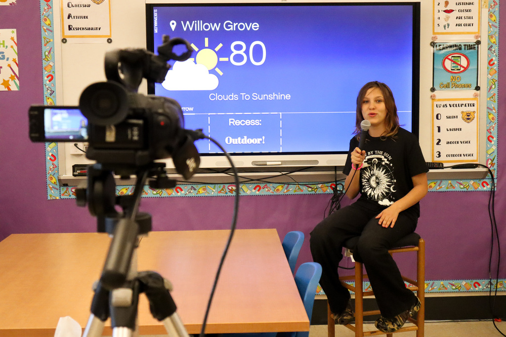 Student acts as Weather Reporter in front of video camera