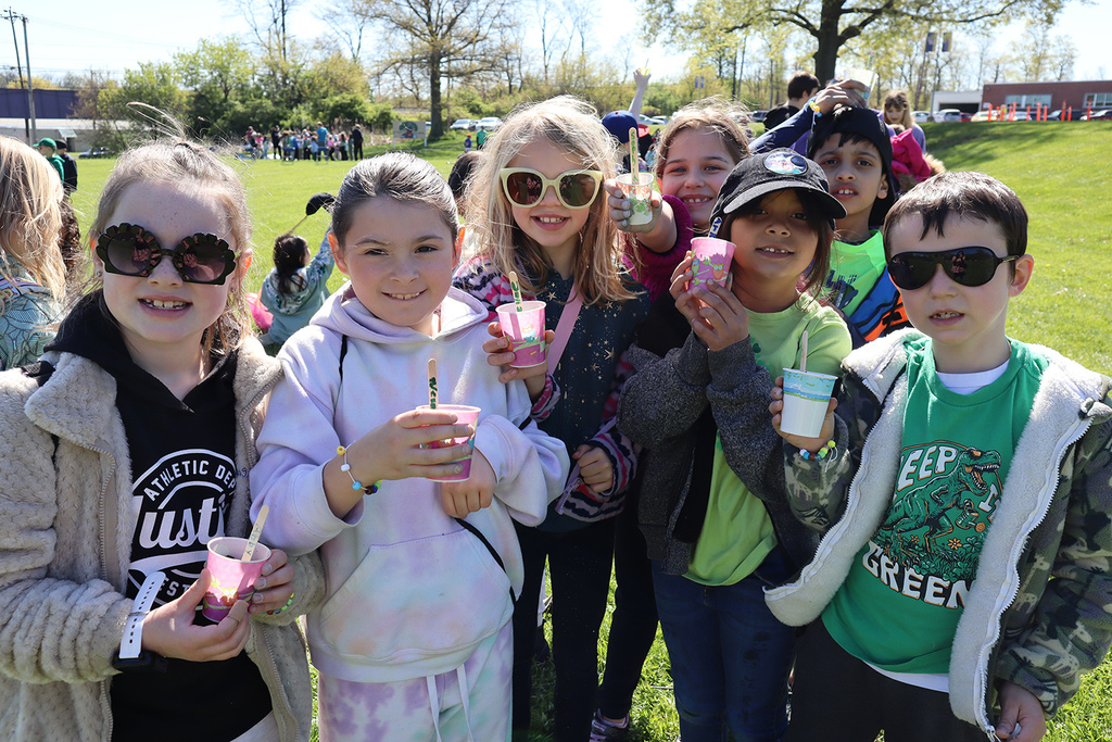 2nd-graders showing off seeds they planted in cups