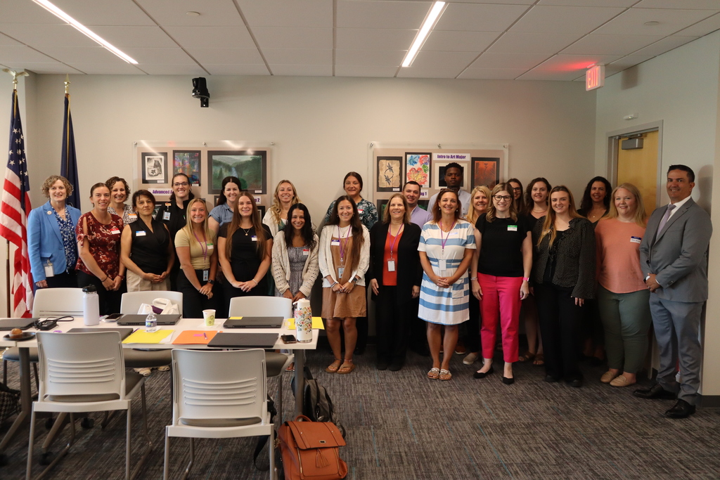 Group of new teachers standing and smiling.