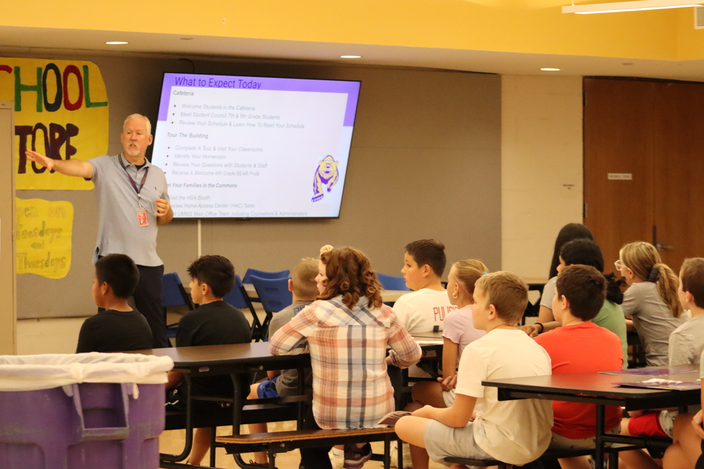 Mr. Burke presenting in the cafeteria to a group of 6th grade students