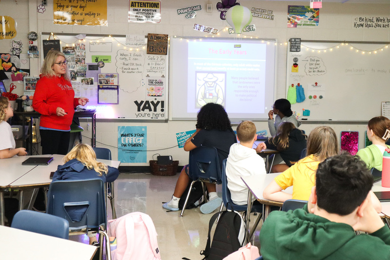 Students listen to a lesson from their teacher