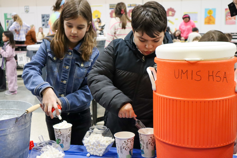 * Two students preparing hot cocoa for themselves