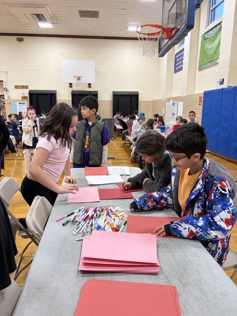 Students from the Leo club working on cards for an assisted living home.