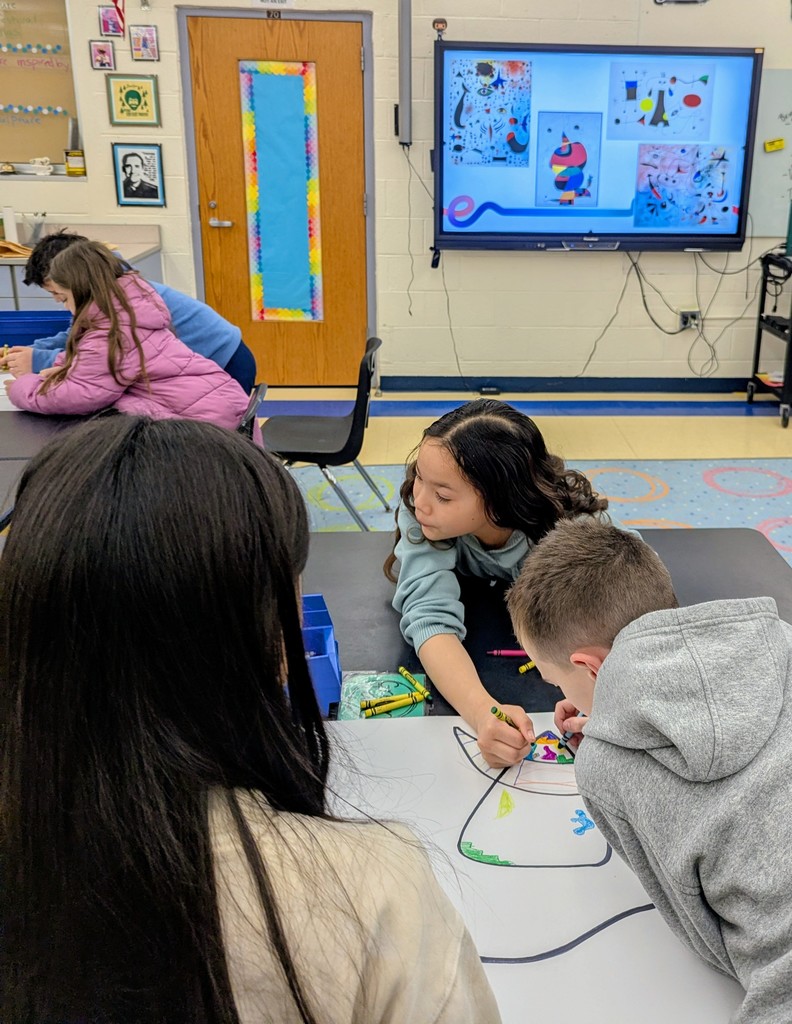 Third graders working together to complete their Miro inspired artwork.