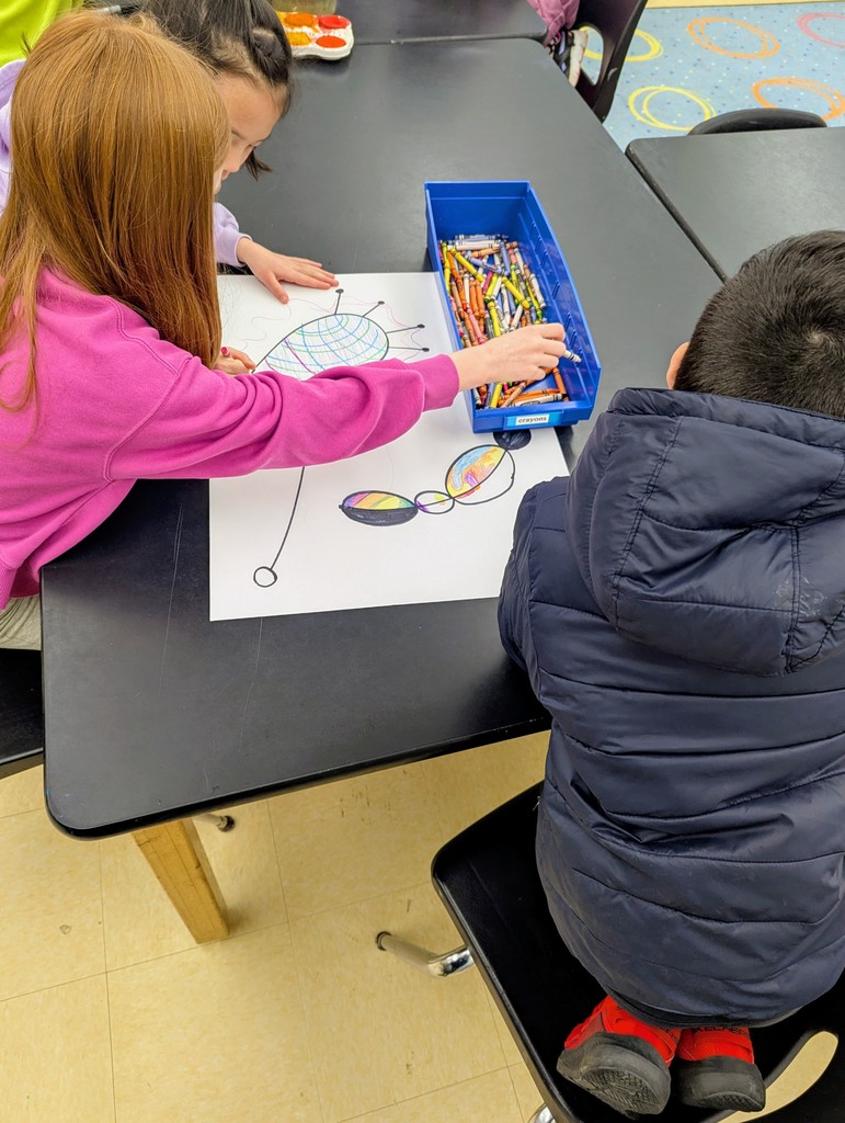 Third graders working together to complete their Miro inspired artwork.