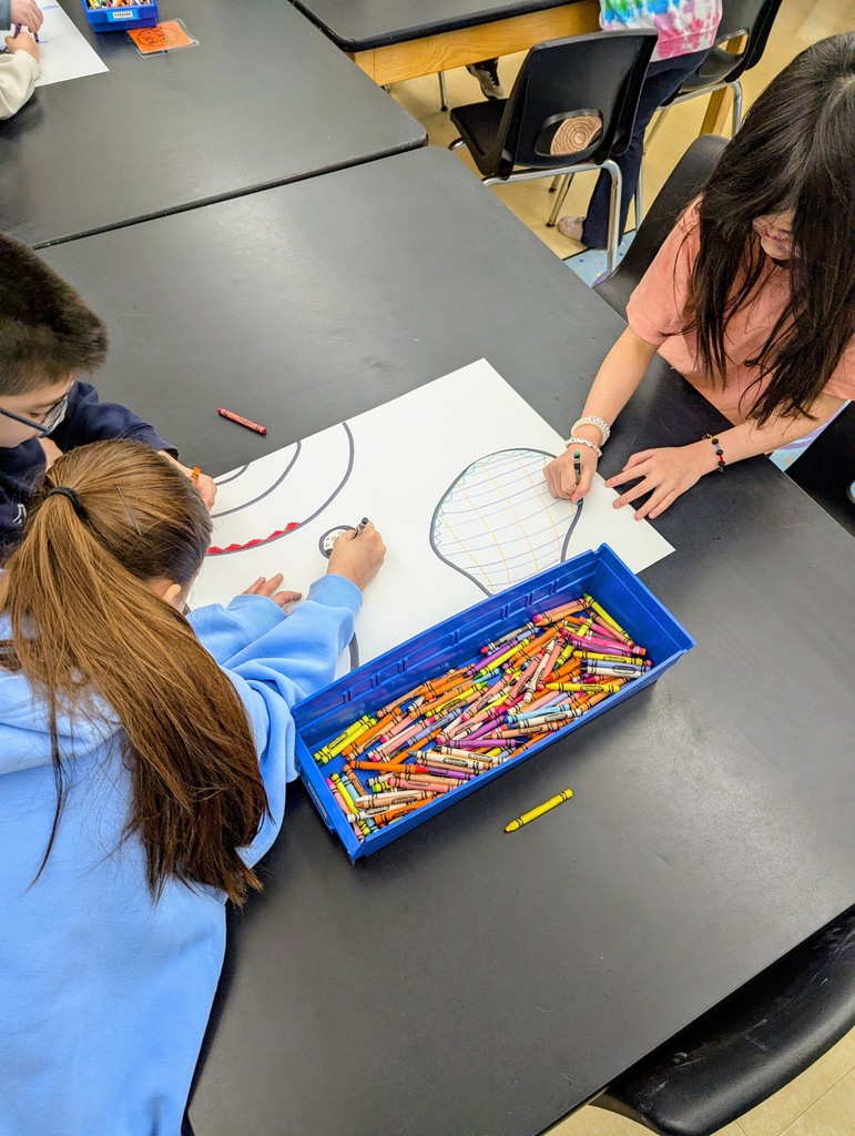 Third graders working together to complete their Miro inspired artwork.