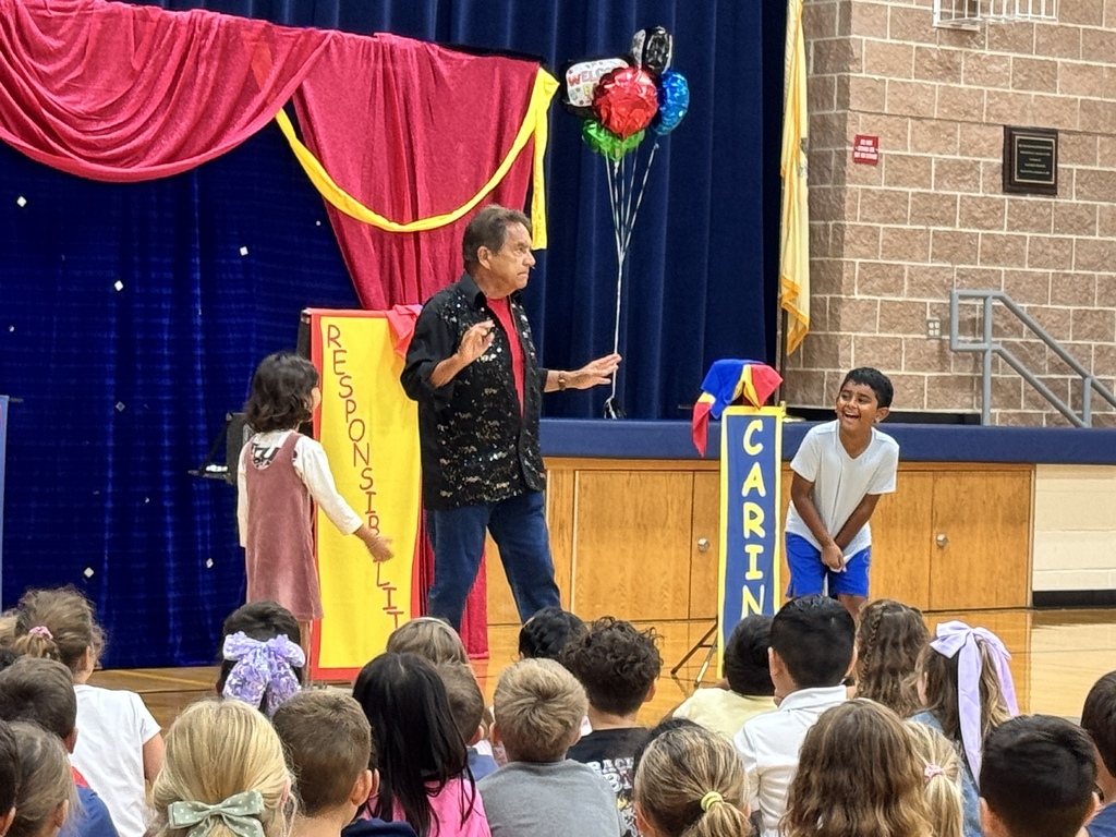 A magician shows off a magic trick with help from students. 