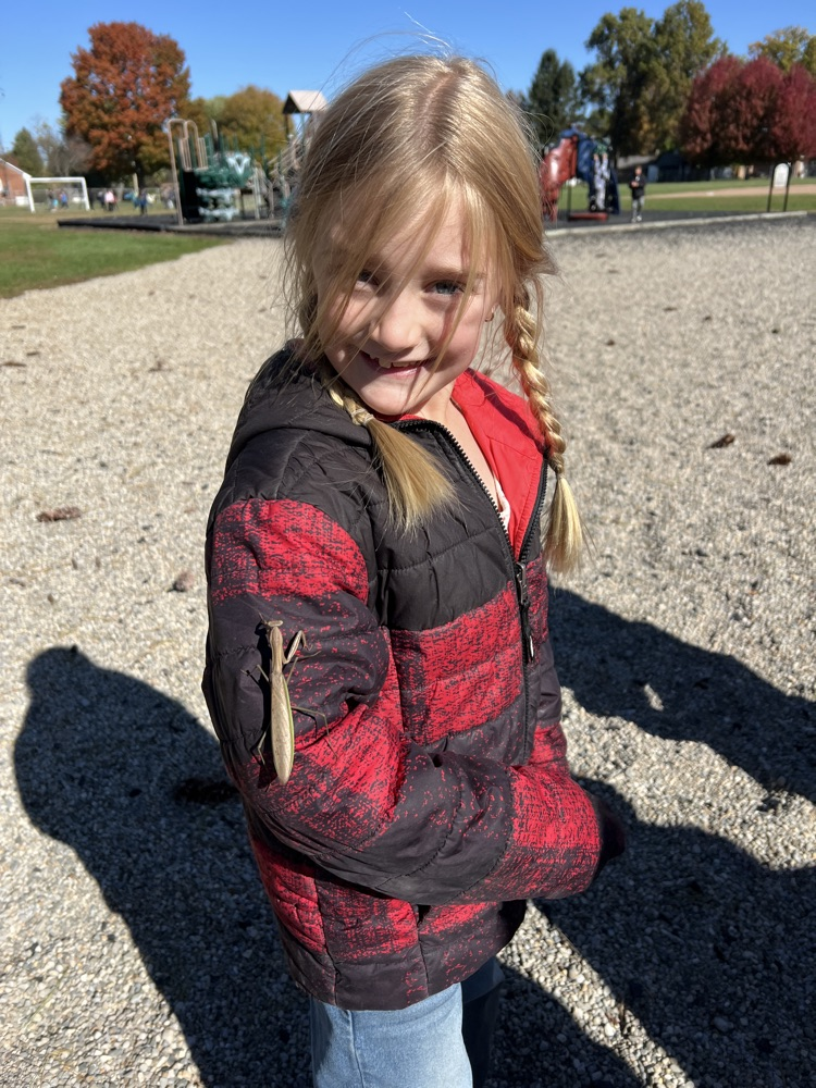 student with praying mantis