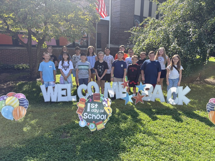 kids with welcome back sign