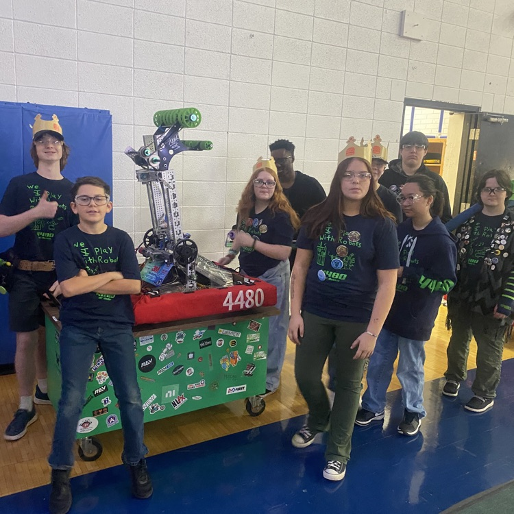 kids standing with robot