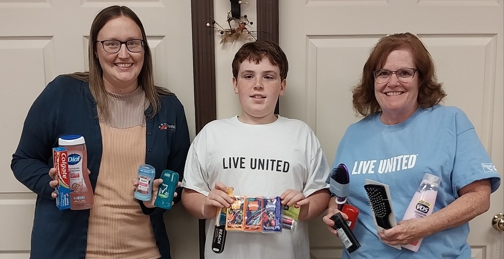 Image of Live United and Freedmon bank holding up various hygeine products to support students of Upshur County Schools.