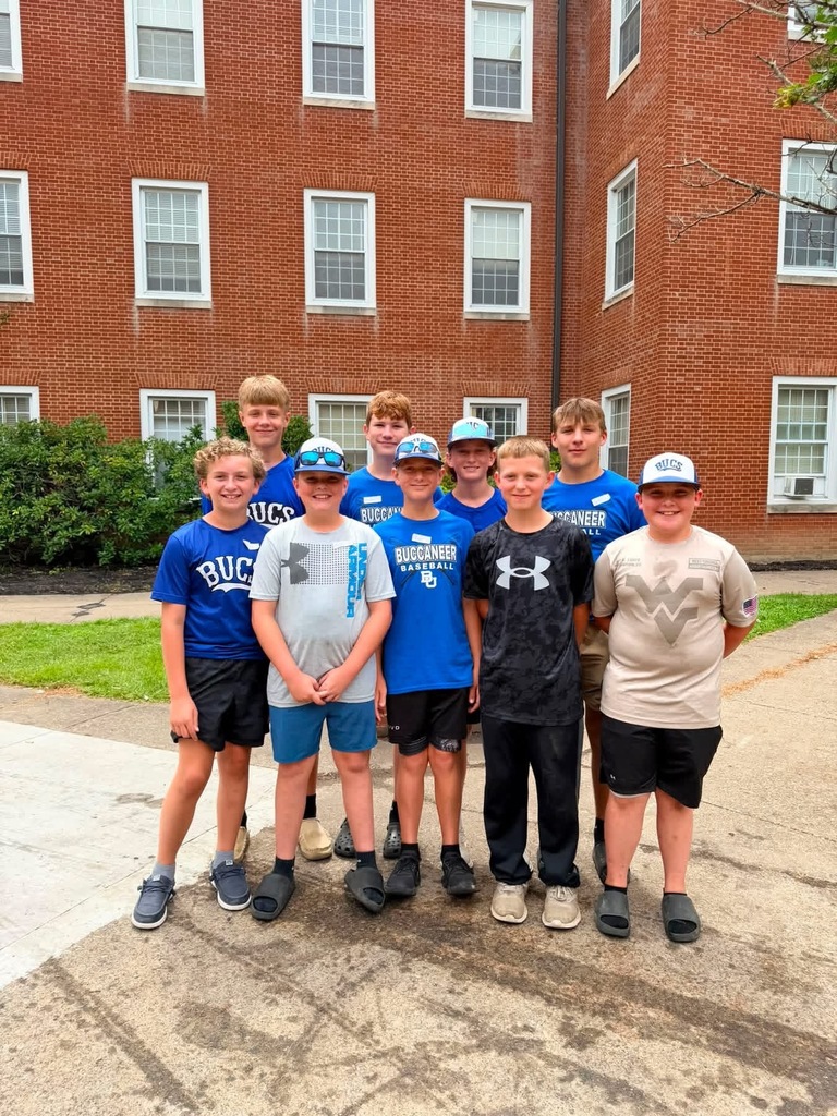Picture of some of the BUMS basketball team helping to work for flood relief. There is a group of boys standing together.