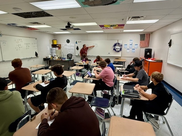Mr. Roy is teaching math to BUHS students in his classroom.