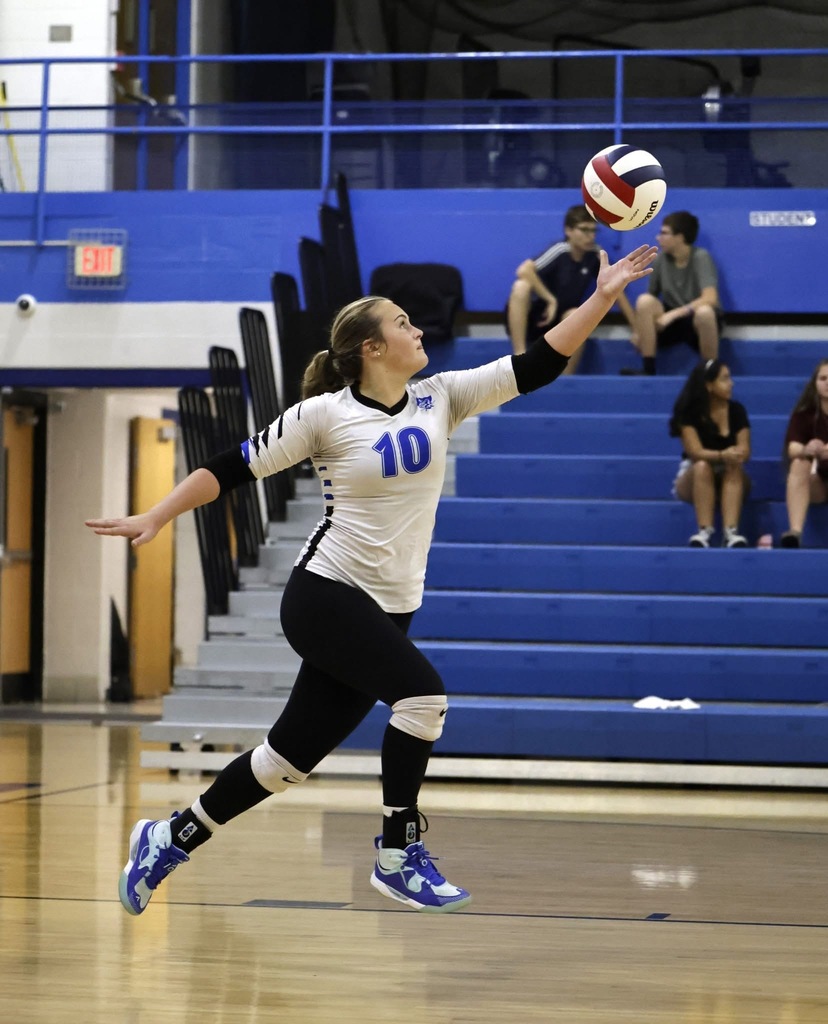 Picture of BUHS female volleyball player about to hit the ball