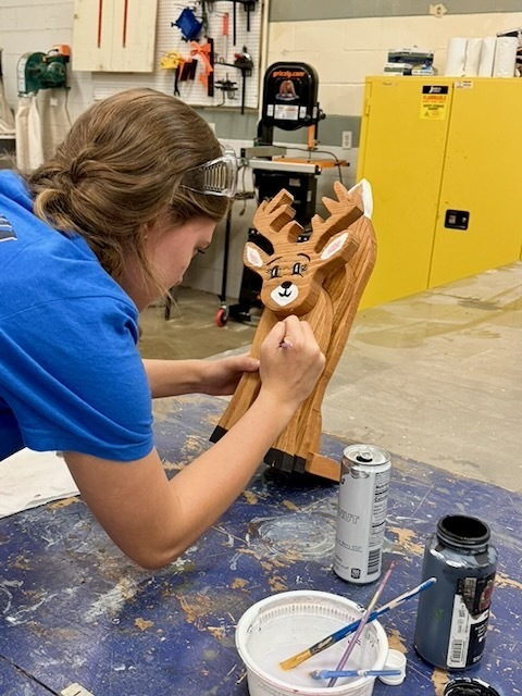 BUHS student painting a deer craft