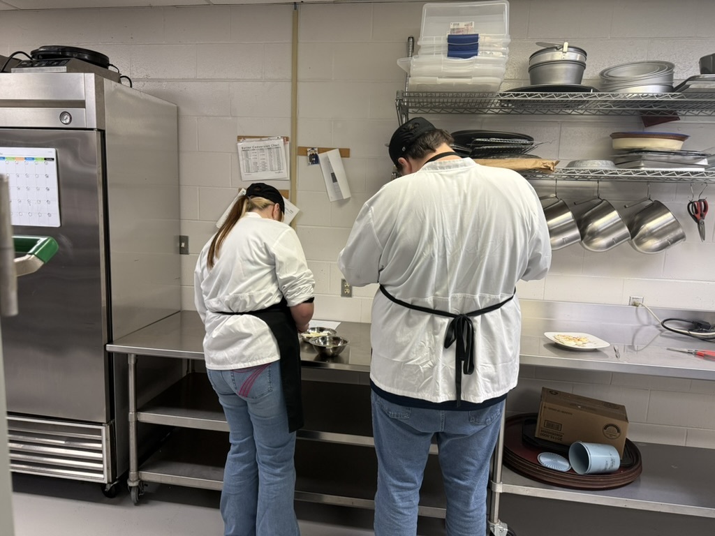 Two BUHS student working in a the culinary learning kitchen,