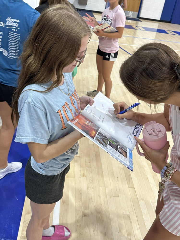 Kena Bonser getting a teacher’s autograph.