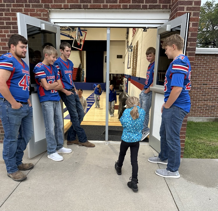 Greeting a kindergarten student coming to school
