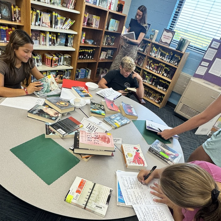 Juniors looking through book selections in the Dystopian genre.