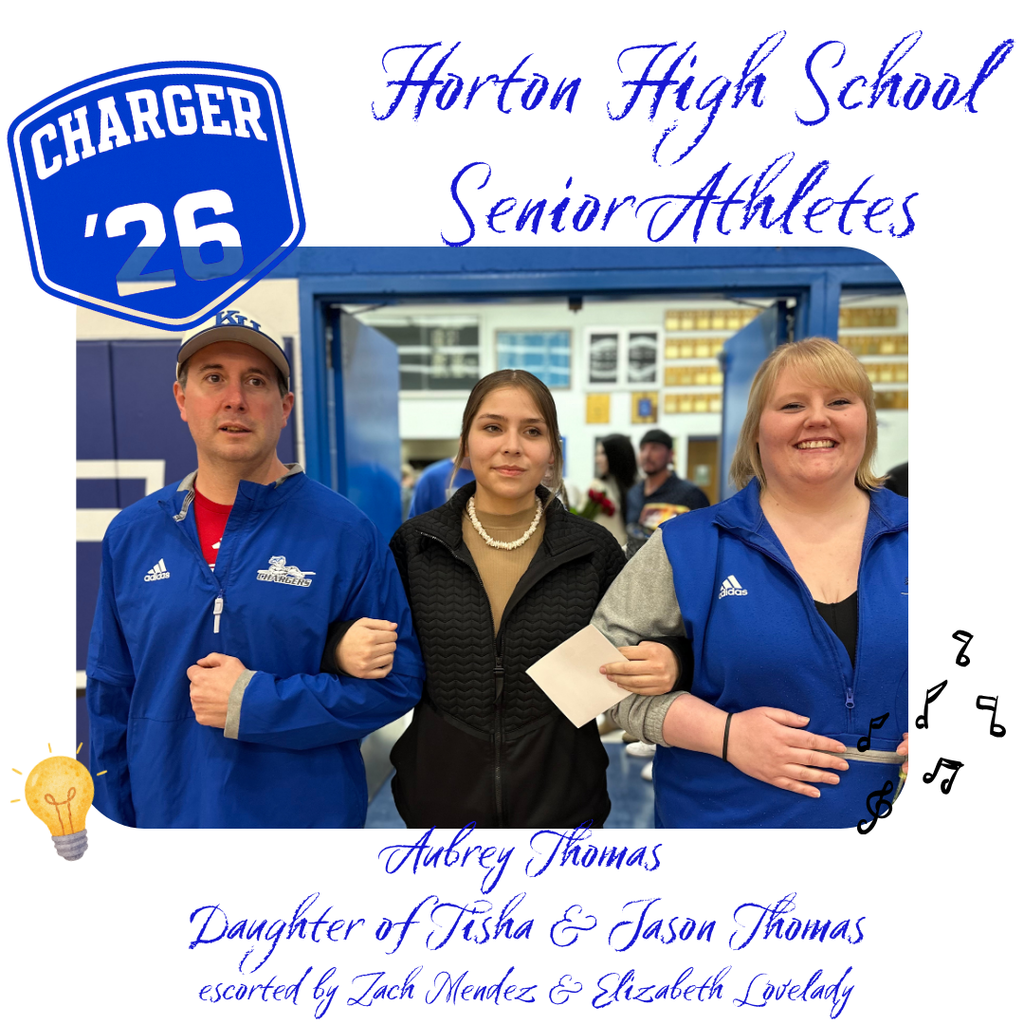 Three people stand in a school corridor. A blue Charger 26 emblem is above them. The woman holds a paper.