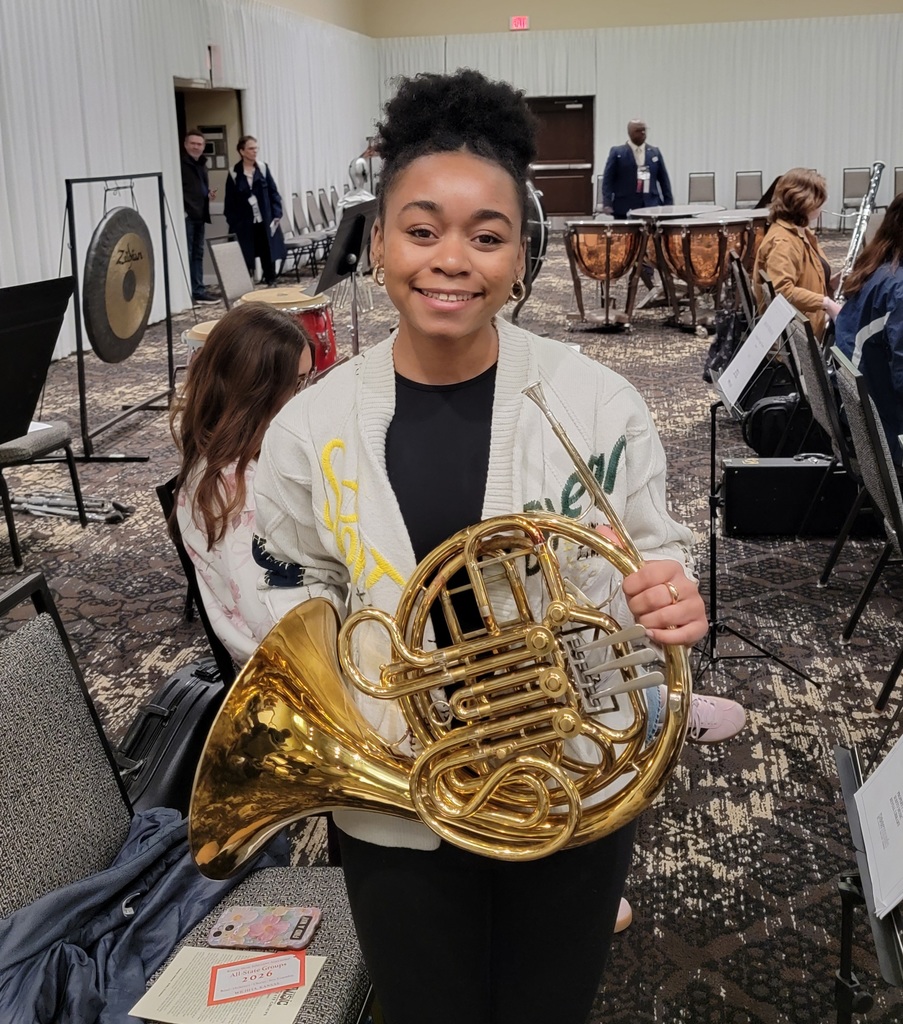 Student holding a french horn