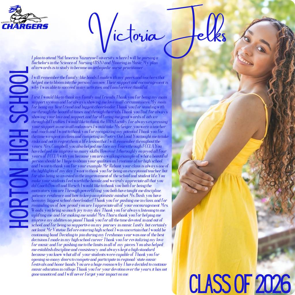 A woman with long curly hair wearing a yellow dress poses with her arms crossed outdoors.